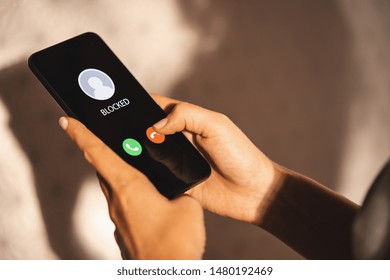 Woman Block a Phone Number or incoming Call from a anonymous stalker or Ex boyfriend. Stalking or bullying with phone concept. Stalker caller, scammer or stranger. Woman blocking incoming call.