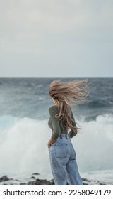 Woman with blonde hair looking at the infinity the sea  - Shutterstock ID 2258049179