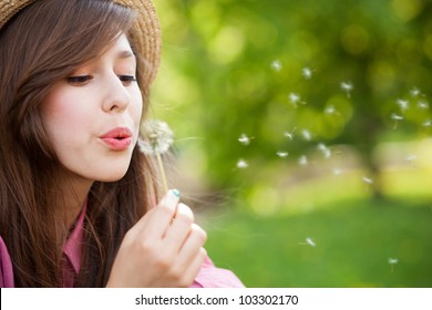 Woman Blowing Dandelion