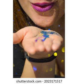 Woman Blowing Glitter From Her Hand