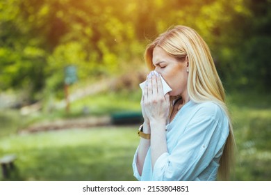 Woman Blowing Her Nose With Handkerchief In Public Parkf. Seasonal Virus Infection. Chronic Disease Control, Allergy Induced Asthma Remedy And Chronic Pulmonary Disease Concept.