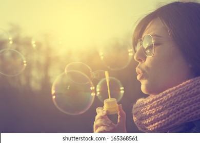 Woman Blowing Soap Bubbles