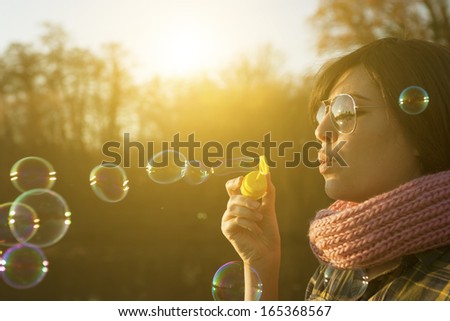 Woman blowing soap bubbles