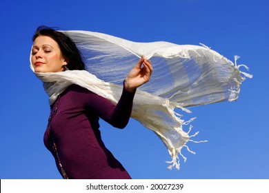 Woman Blowing In The Wind With A Scarf