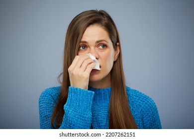 Woman blows his runny nose in napkin. Isolated female portrait healthcare and medical concept.