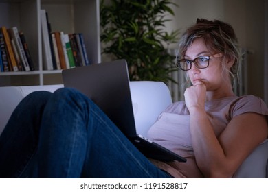 Woman With Blue Display Light Watching Notebook