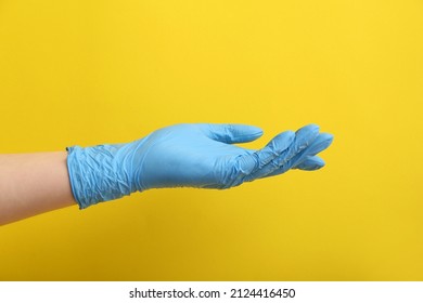 Woman In Blue Medical Glove On Yellow Background