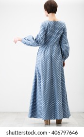 Woman In The Blue Polka Dots Dress On The White Background