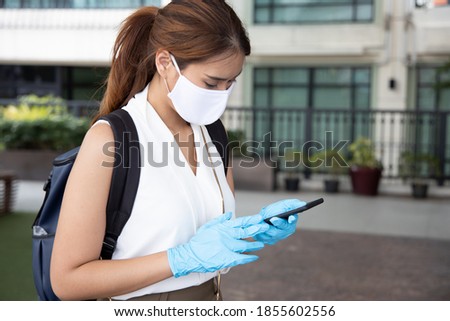woman with blue rubber glove using smartphone, concept of telemedicine, online shopping, online food or grocery delivery order, new norm, new normal social distancing, personal distancing technology