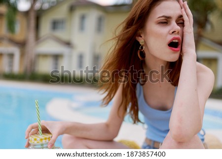 woman in blue swimwear for hotel pool enjoying luxury tropics