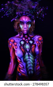 Woman blur with ultraviolet body art