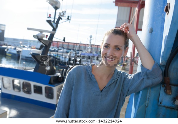 woman boat worker looking\
at camera