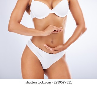 Woman, body and hands frame stomach for skincare beauty, fitness wellness or model liposuction in studio. Cosmetic tummy tuck, dermatology care and digestion or gut balance with person in underwear