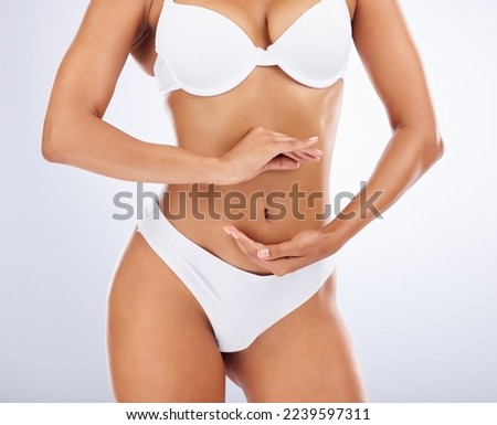 Woman, body and hands frame stomach for skincare beauty, fitness wellness or model liposuction in studio. Cosmetic tummy tuck, dermatology care and digestion or gut balance with person in underwear