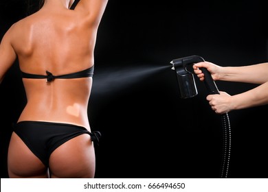 Woman body paint with airbrush in professional beauty salon - Shutterstock ID 666494650