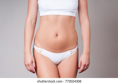 Woman body. Plastic surgery. Woman showing fat on her belly.