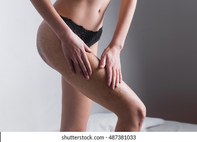 Woman body with scrub coffee grounds. Body care concept.