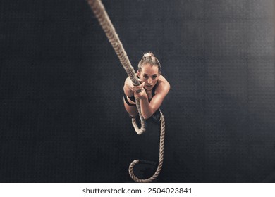 Woman, bodybuilder and climb rope for fitness at gym for bodybuilding with strength and determination. Female person, muscles and strong on training, workout and exercise for health and above - Powered by Shutterstock