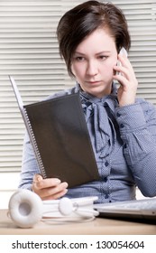 Woman With Book Talking By Phone