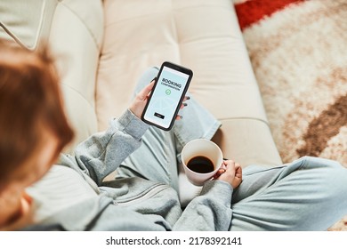 Woman Booking Vacation Online. Person Paying For Hotel From Home. Booking Flight Using Mobile Payment App. Purchasing Service Using Smartphone. Online Shopping From Home. Order Confirmation On Screen