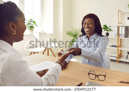 Woman borrows money. Female employee receives salary. Client meets with private loan lender, signs contract agreement and takes cash. Credit company worker hands over USD banknotes to happy customer