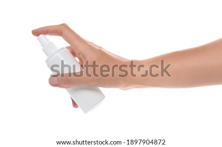 Woman with bottle of insect repellent spray on white background, closeup