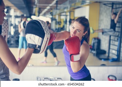  Woman Boxer Hitting The Glove Of His Sparring Partner. Woman Workout In Gym.