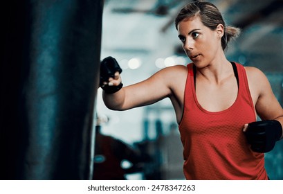 Woman, boxer and punching bag in gym for training for power, speed and development for contest. Person, fighter and strong with gloves for challenge, exercise and workout for martial arts combat - Powered by Shutterstock