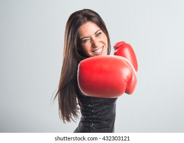 Woman With Boxing Gloves Over Grey Background