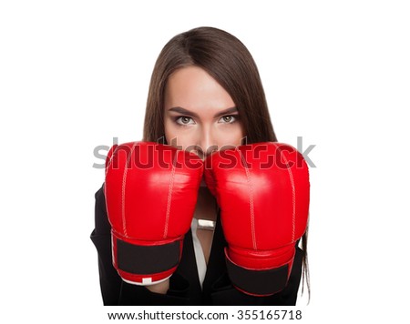Woman with boxing gloves and strict office clothes