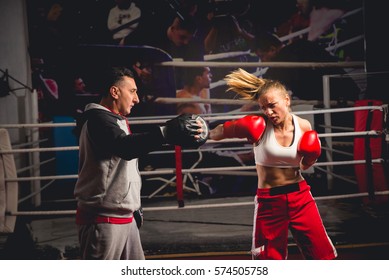 Woman Boxing  With Her Trainer