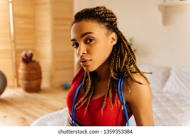 Woman With Braids. Beautiful Dark-eyed Young Woman With Nice Little Braids Wearing Short Red Top