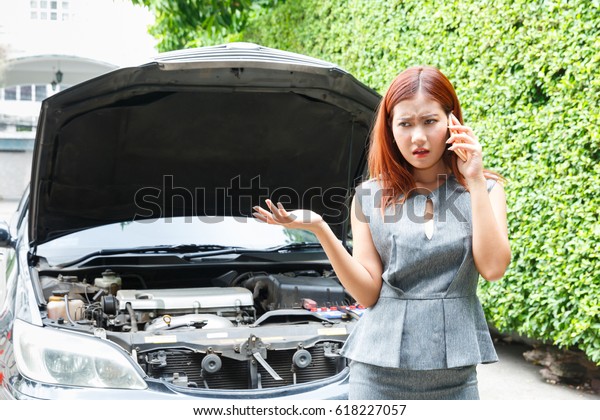 Woman with breakdown car calling roadside\
service to fix the engine failure, emergency automotive vehicle\
insurance for lady, auto support\
concept