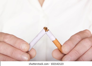 Woman Breaking A Cigarette