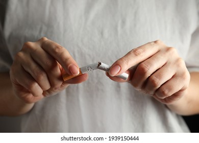 Woman Breaking Cigarette, Closeup. Quitting Smoking Concept