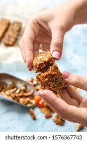 Woman Breaking Tasty Granola Bar, Closeup