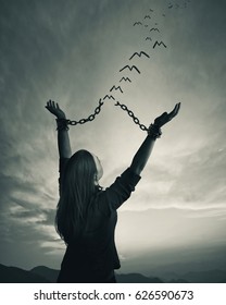 A woman breaks her chains as the links turn into freedom birds
