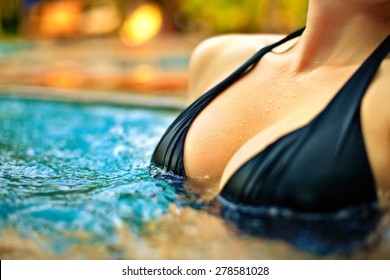 woman breast with drops close up