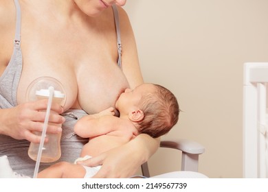 Woman breastfeed baby use breast pump at the same time showing concept of breastfeeding