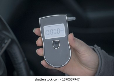 A Woman With A Breathalyzer In The Car, Testing For Alcohol And Drug Intoxication Of The Driver, Selective Focusing Tinted Image