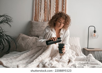 Woman Brewing Coffee On Bed