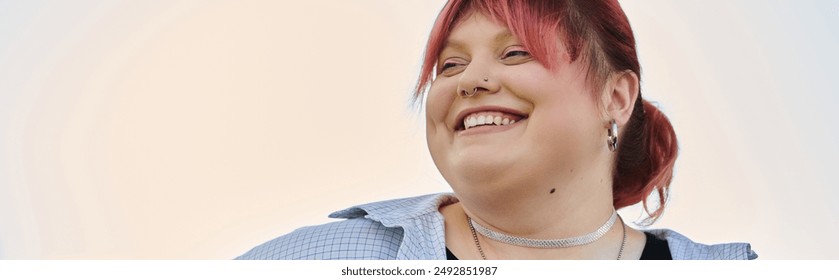 A woman with bright red hair smiles radiantly, enjoying a moment of peace at home. - Powered by Shutterstock