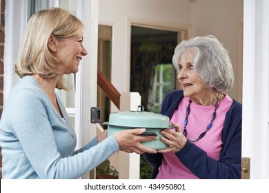 Woman Bringing Meal For Elderly Neighbour