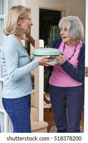 Woman Bringing Meal For Elderly Neighbour