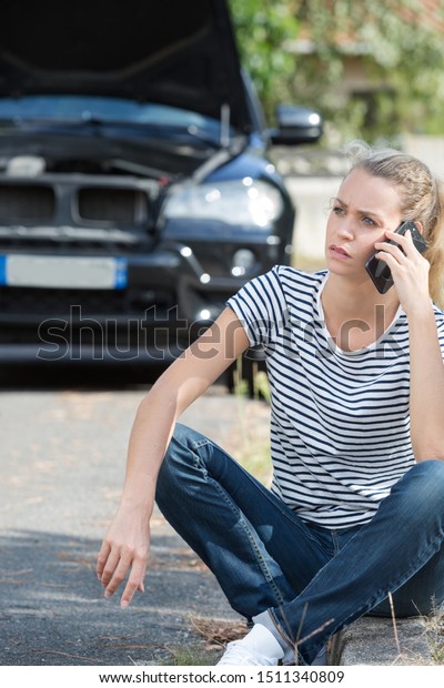 woman and broken down car\
on street