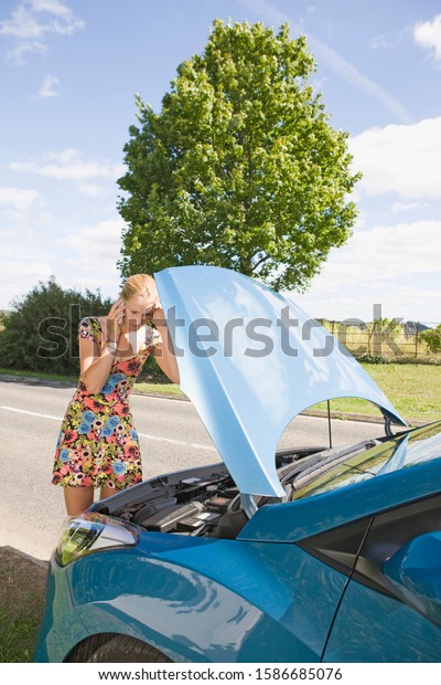 Woman With
Broken Down Car Phoning For
Assistance