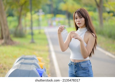 A Woman Brought The Plastic Water Bottle That Has Been Drained Of Water, Sorted Into Prepared Bins For Storage For Recycling