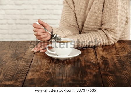 woman in brown color white wall and hot coffee 