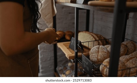 Woman browsing fresh bread and pastries in a cozy bakery shop - Powered by Shutterstock