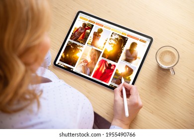 Woman browsing photos online on tablet computer